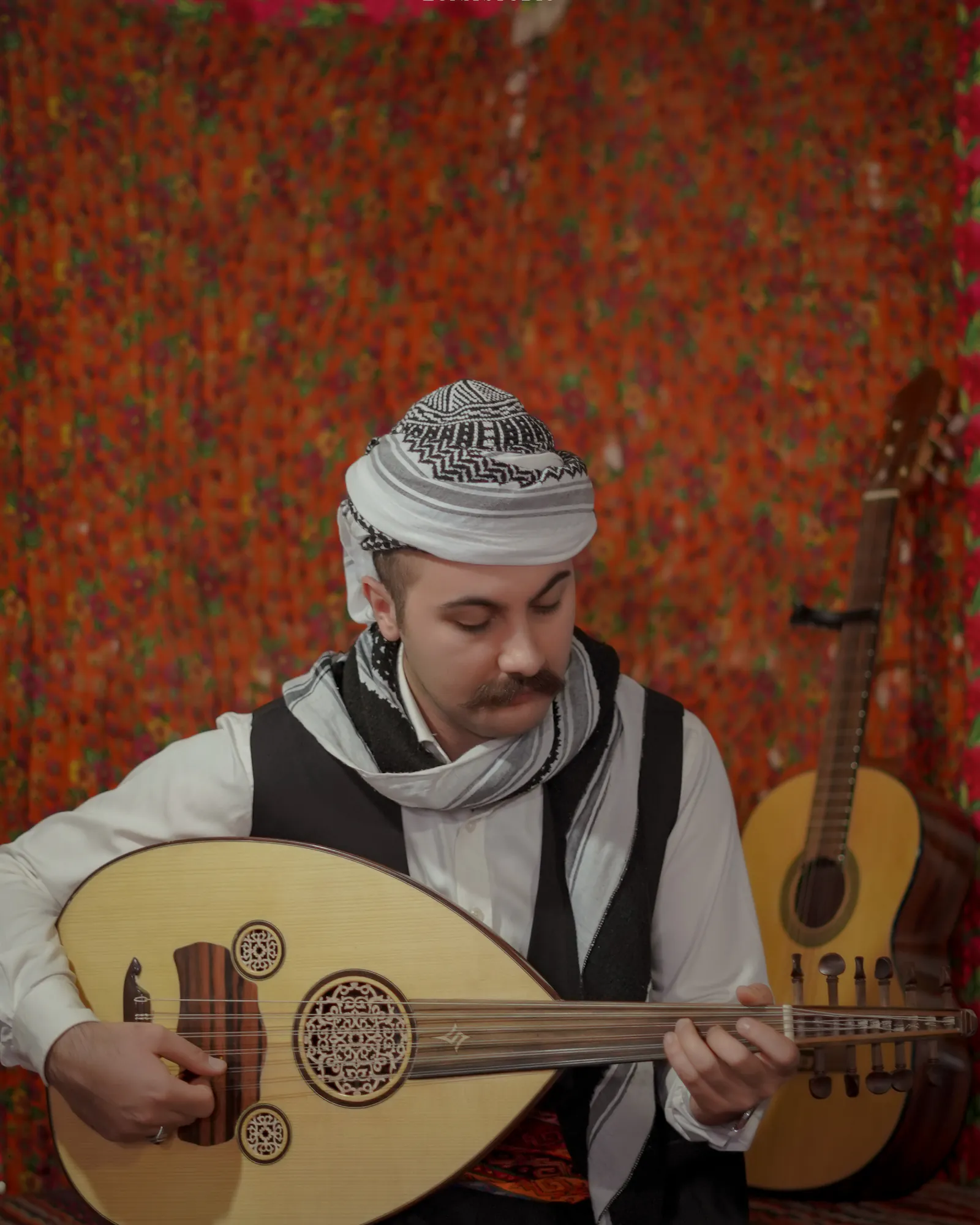 Ismail Kalaki playing Oud in traditional Kurdish dress.