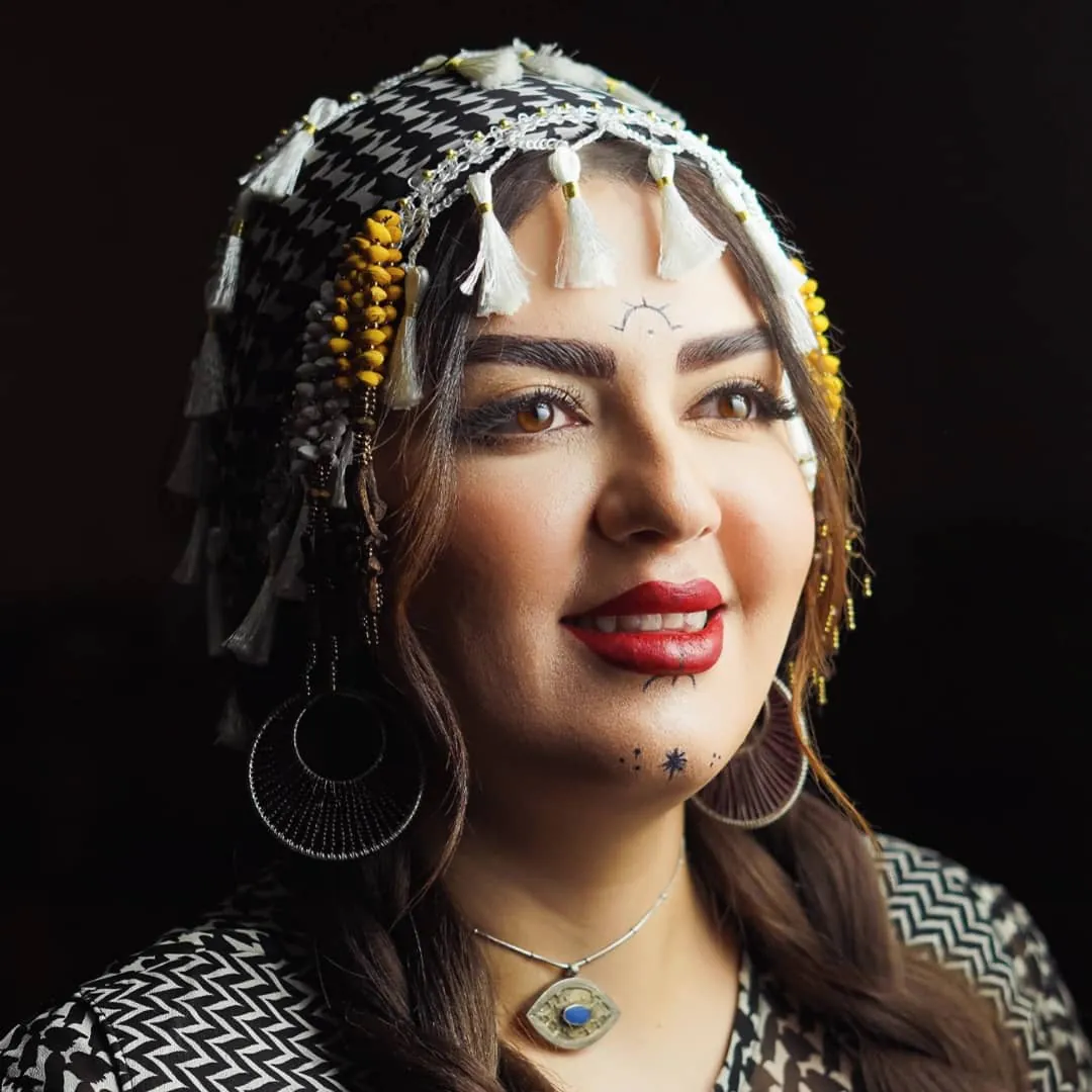Editorial portrait of Leila Azimi in Kurdish dress.