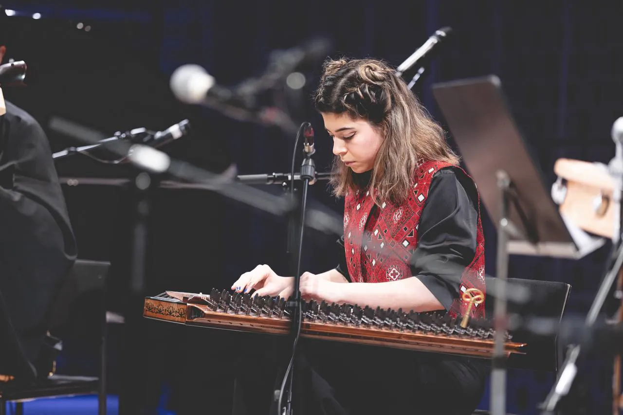 Sara Majidinejad playing Qanun with an ensemble.